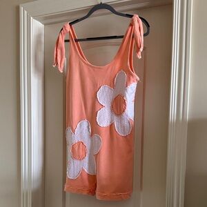 Orange Romper with White Floral Design